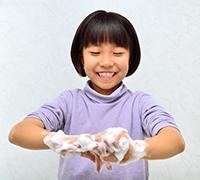 young girl washing her hands